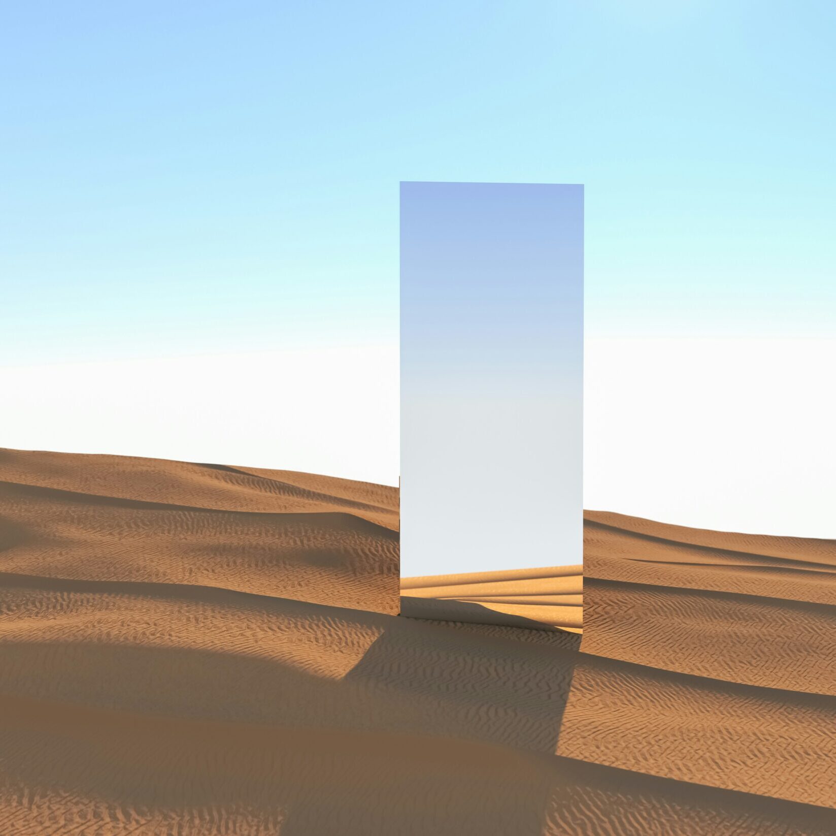 A rectangular mirror in the desert sand with a blue sky in the background.