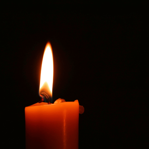 A single candle in a dark room.