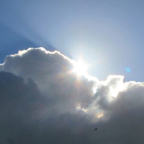 Bright sun light shining from behind the cloud.