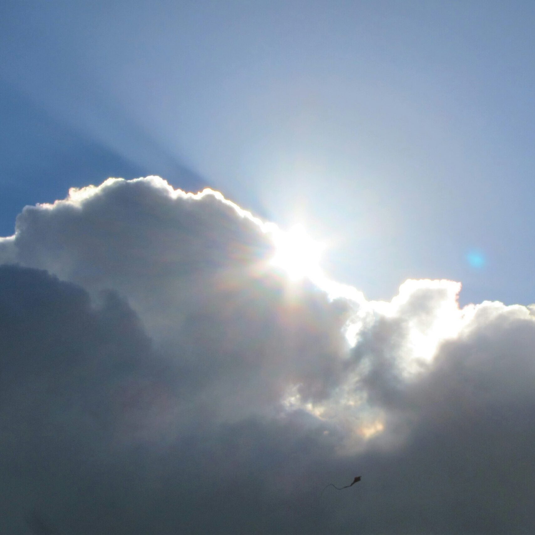Bright sun light shining from behind the cloud.